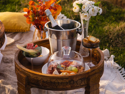 Luxury picnic setup in Madeira with champagne, flowers and romantic decor