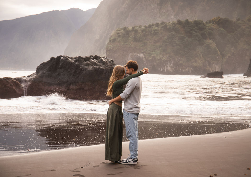 Romantic engagement portrait on the black sand beach of Seixal in Madeira