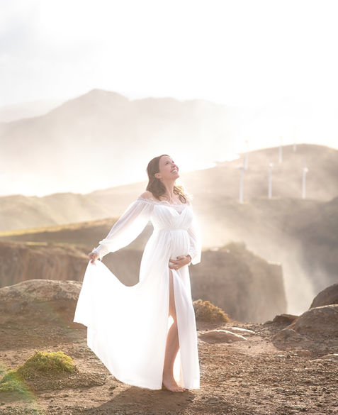 Outdoor maternity photoshoot in Madeira on dramatic ocean cliffs at sunrise