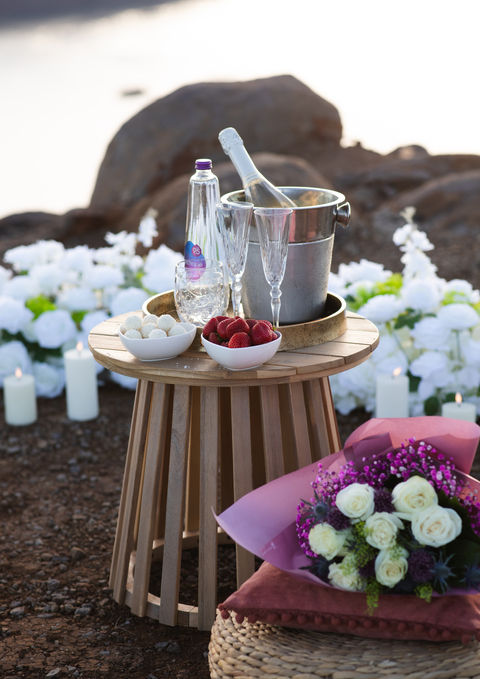 Luxury proposal champagne setup in Madeira featuring fresh flowers, premium champagne, elegant styling, and spectacular Atlantic Ocean cliff views.