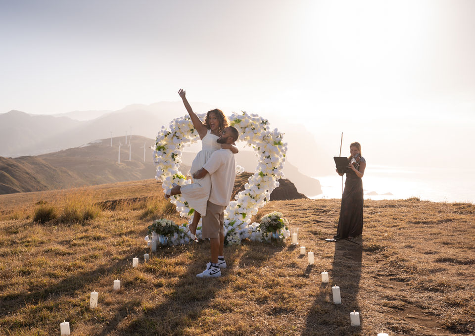 Luxury Golden Heart Proposal in Madeira with a floral heart arch and live violin performance
