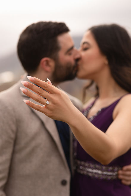 Close-up of engaged couple kissing after a romantic proposal picnic in Madeira