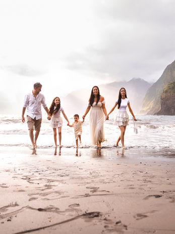 Family walking along Seixal Beach during a family photoshoot in Madeira