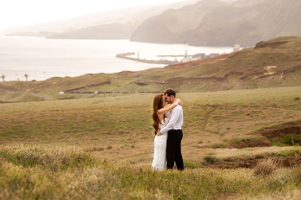 Romantic elopement in Madeira with a couple embracing in a scenic coastal landscape during an intimate wedding experience.