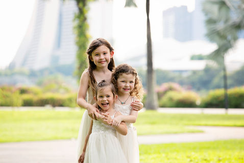 Sibling girls standing in a garden at Gardens by the Bay East Side – family photography Singapore