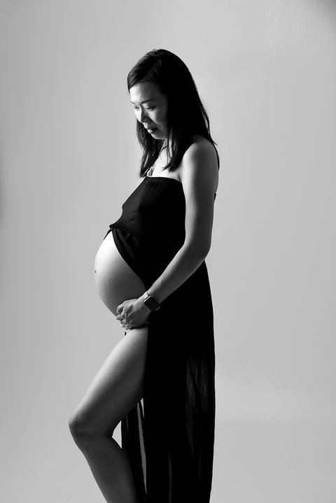 Black and white fine art maternity photo of pregnant woman in studio Singapore