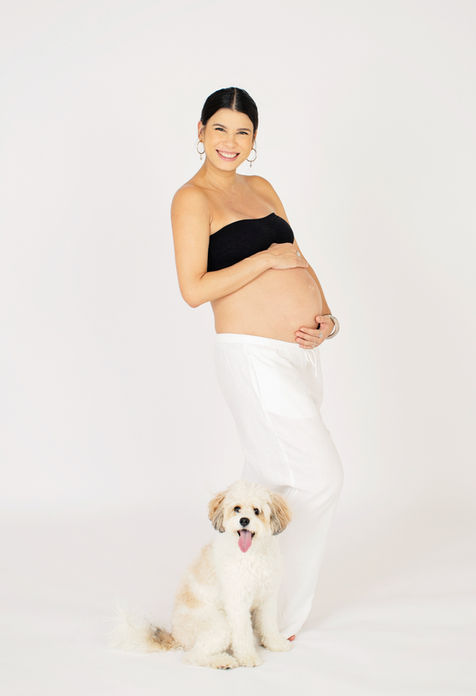 Pregnant woman with dog in casual outdoor maternity shoot, Singapore.