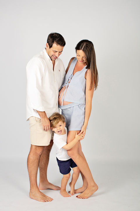 Family maternity studio photo with pregnant mother, father, and young child in Singapore