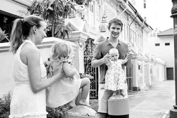 Mother and daughters walking along colorful Peranakan shophouses in Joo Chiat, Singapore, during a vibrant family photography session
