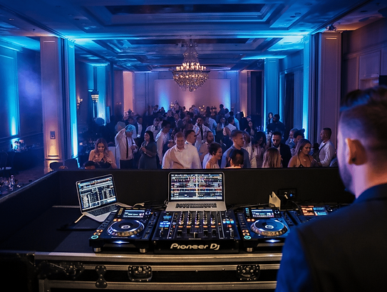 A-DJ-performing-at-corporate-party.-The-DJ-booth-is-equipped-with-professional-gear-includ