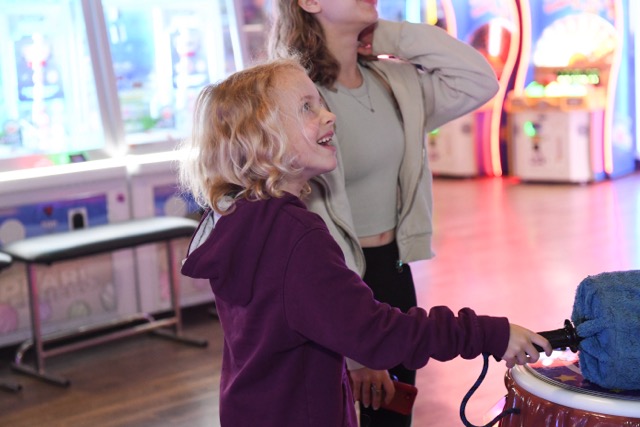 two children playing a classic arcade game