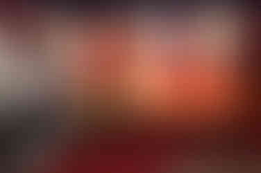 People at Ringling Bros Barnum Bailey Circus sign, looking at carnival games.