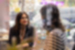 Woman in interview, wearing rainbow lanyard