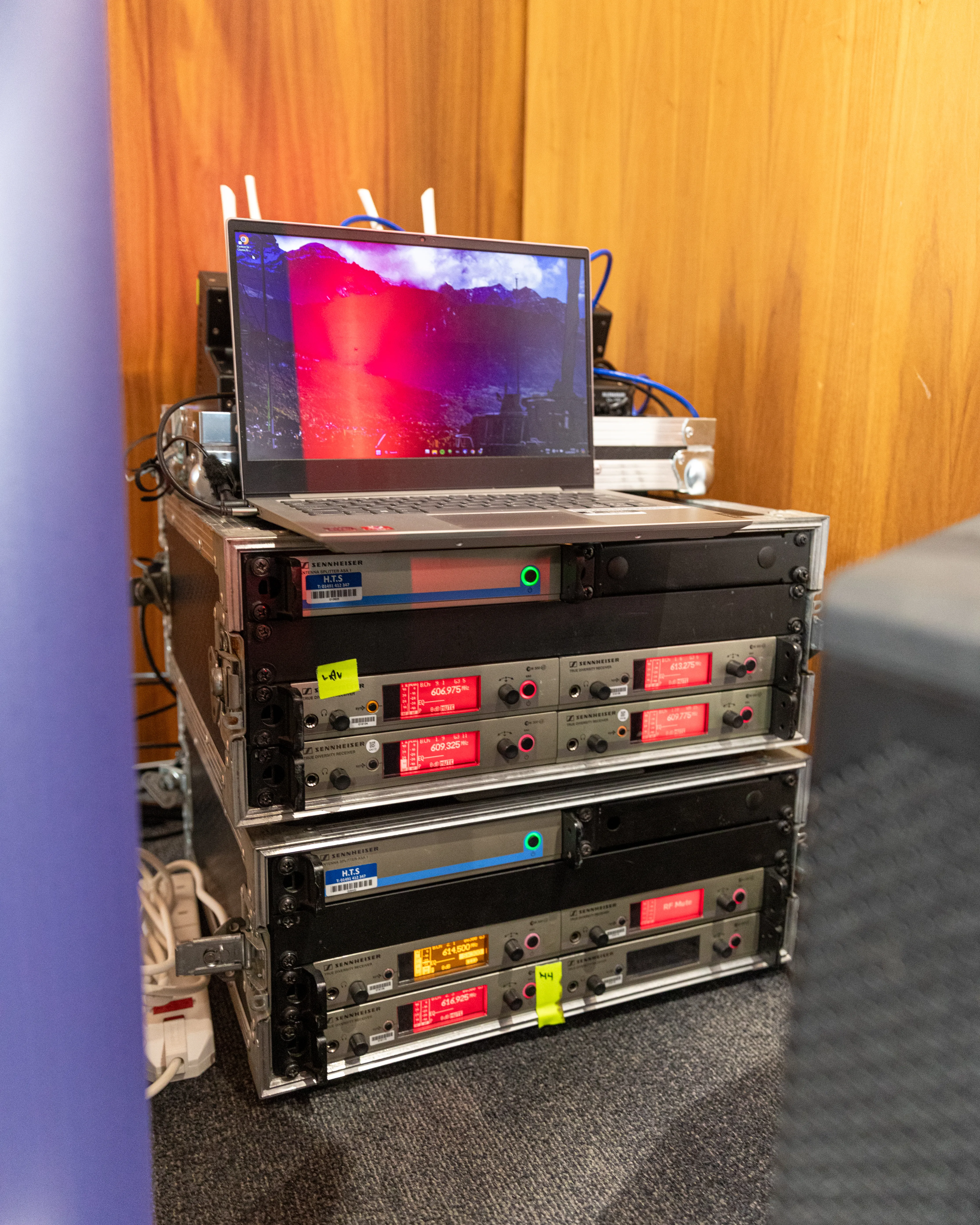 Vertical behind-the-scenes shot of the discreet AV and lighting setup at the Rakuten Symphony event