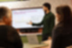 Man presenting data graph to colleagues