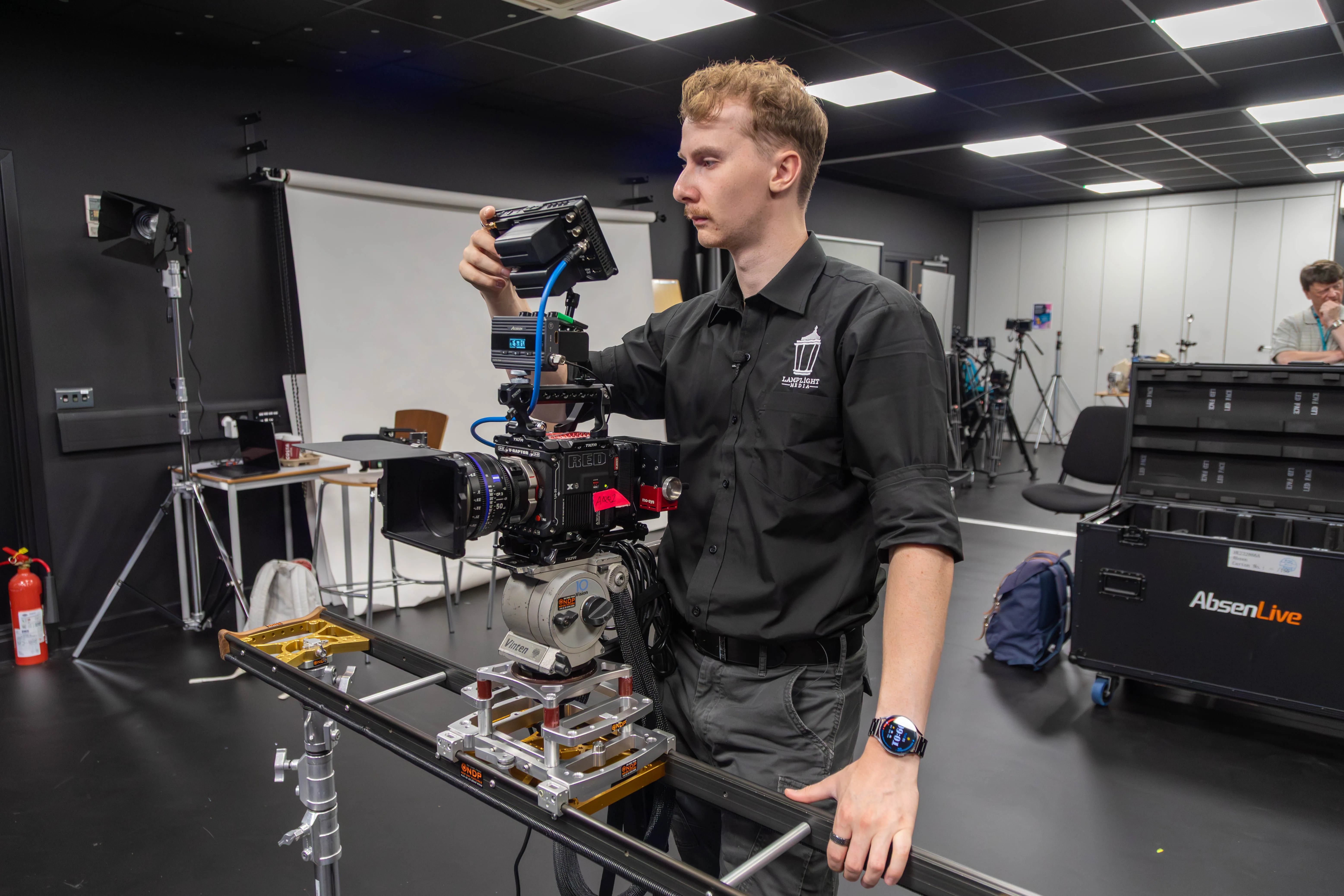 Behind the scenes of a virtual production set with crew and equipment