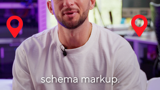 A man in a white shirt sits indoors, surrounded by location pin icons, with the words “schema markup.” displayed in front of him.