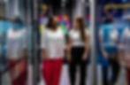 Two women colleagues walking and chatting in modern office