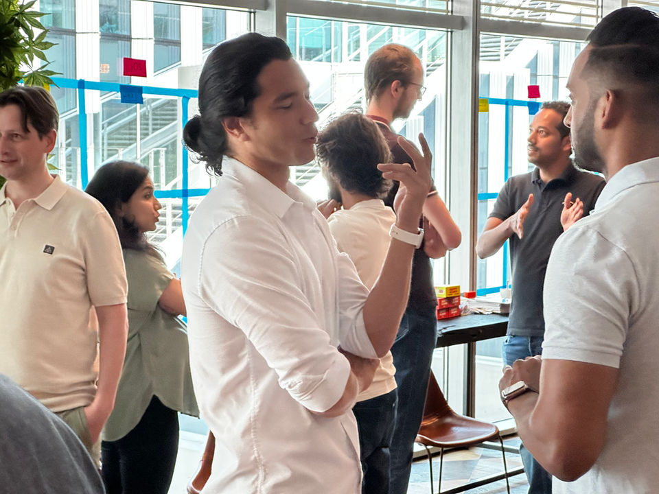 Group of colleagues having a conversation in an office setting.
