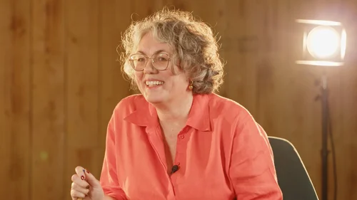 Presenter speaking to camera in the industrial-style studio set
