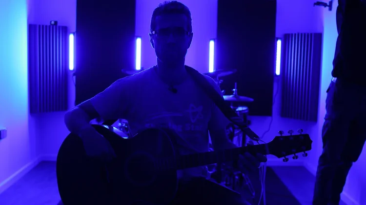 Set and forget lighting setup framing the guitarist's stool position