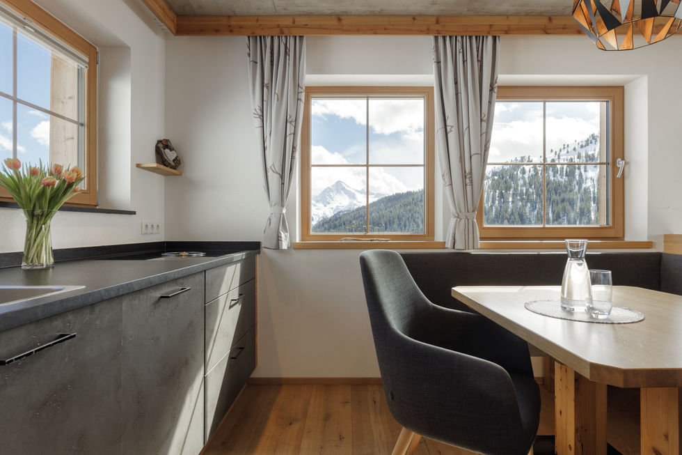 a kitchen with a view of a mountain in the window