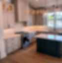 Two-tone kitchen with white cabinets, blue island and white countertops