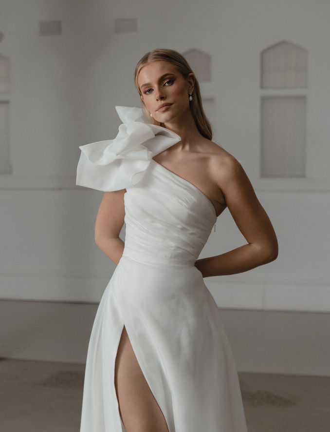 Selwyn Madi lane ballgown ivory organza  asymmetrical bodice a line dramatic skirt shoulder bow high split skirt  elegant statement wedding dress gown