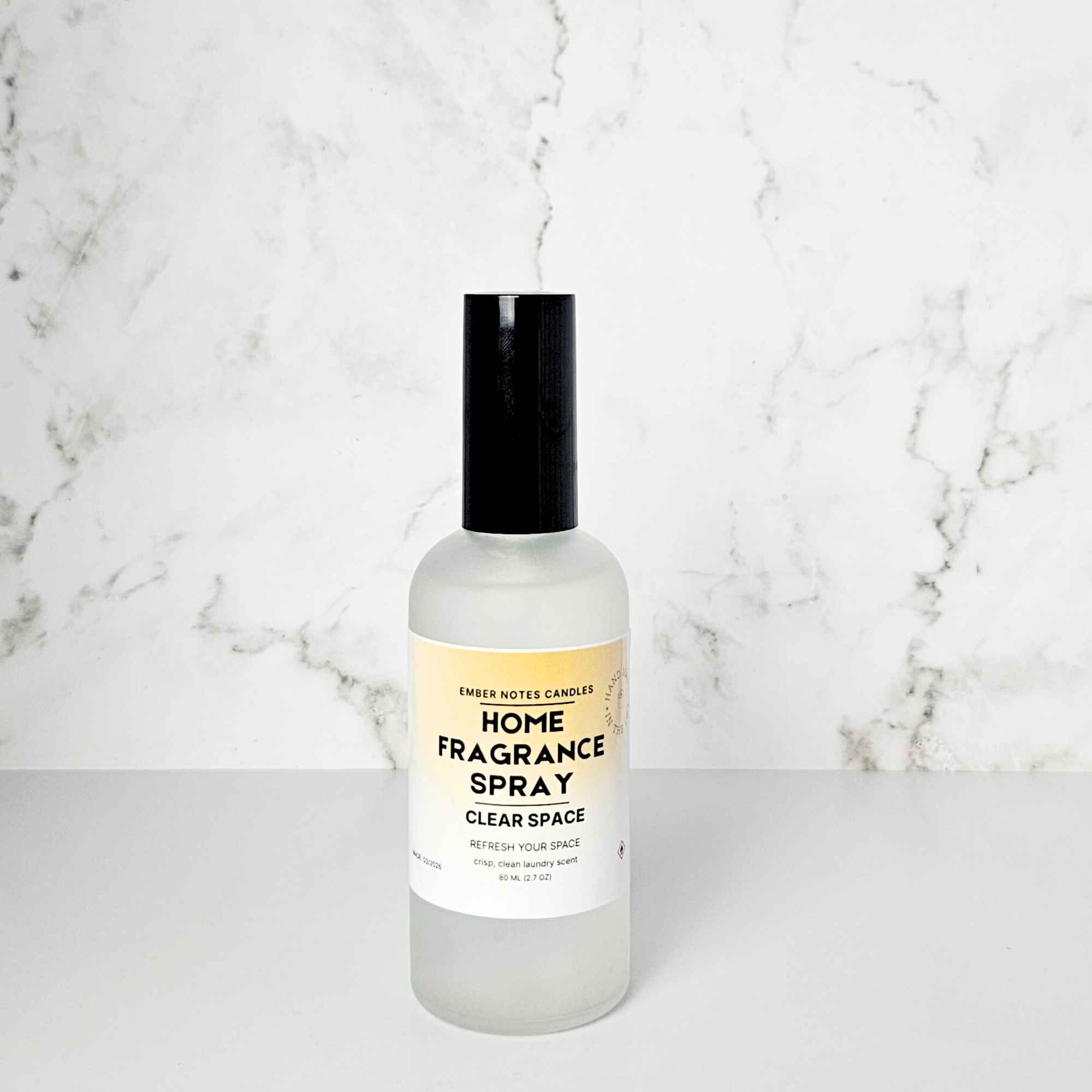 fragrance spray in front of marble background