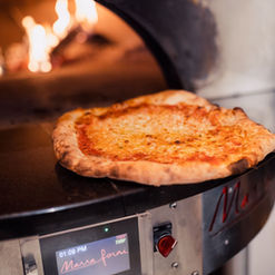 Marghrita pizza coming out the oven