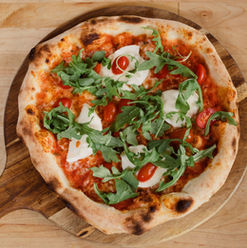 Pizza with cheese, arugula and cherry tomatoes
