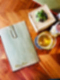 Sample menu and drink on a wood table
