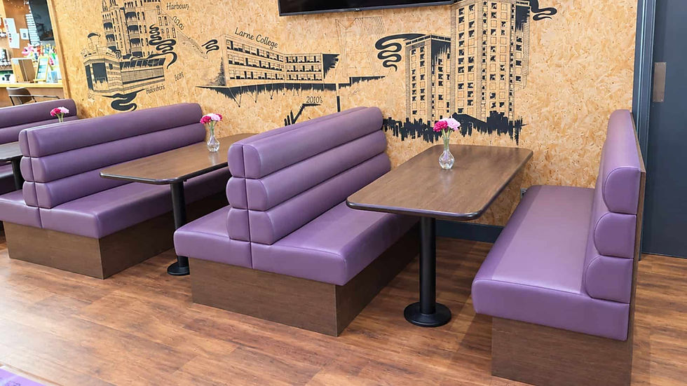 Bespoke restaurant booth seating in purple fluted vinyl with dark wood bases and matching tables, designed and manufactured by Target Furniture Ltd for The Clockwork Beer Company.