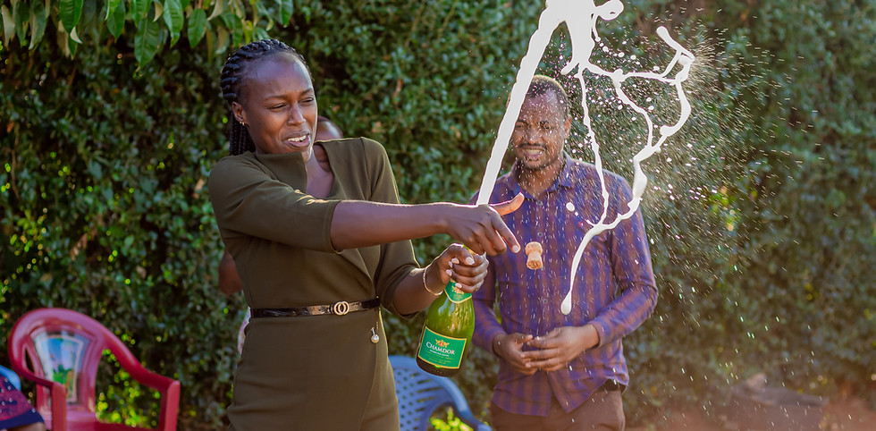 A woman popping champagne at a Truthvision Media event.