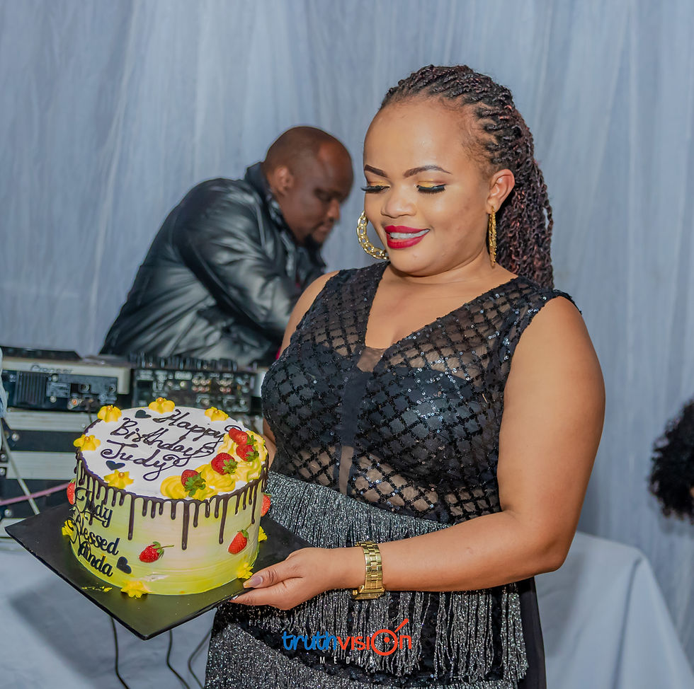 Woman holding a birthday cake by Truthvision Media