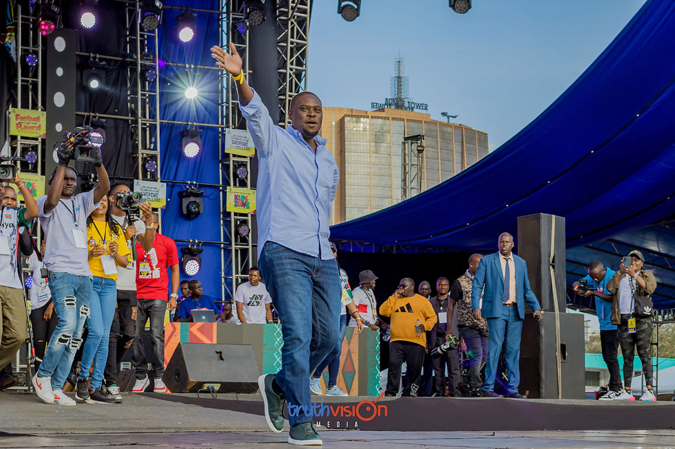 Man waving on stage at a Truthvision Media event