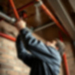 a man installing a fire sprinkler system.jpg
