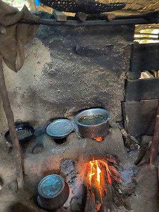 Cooking maize for the cattle in a shed in the herding camp