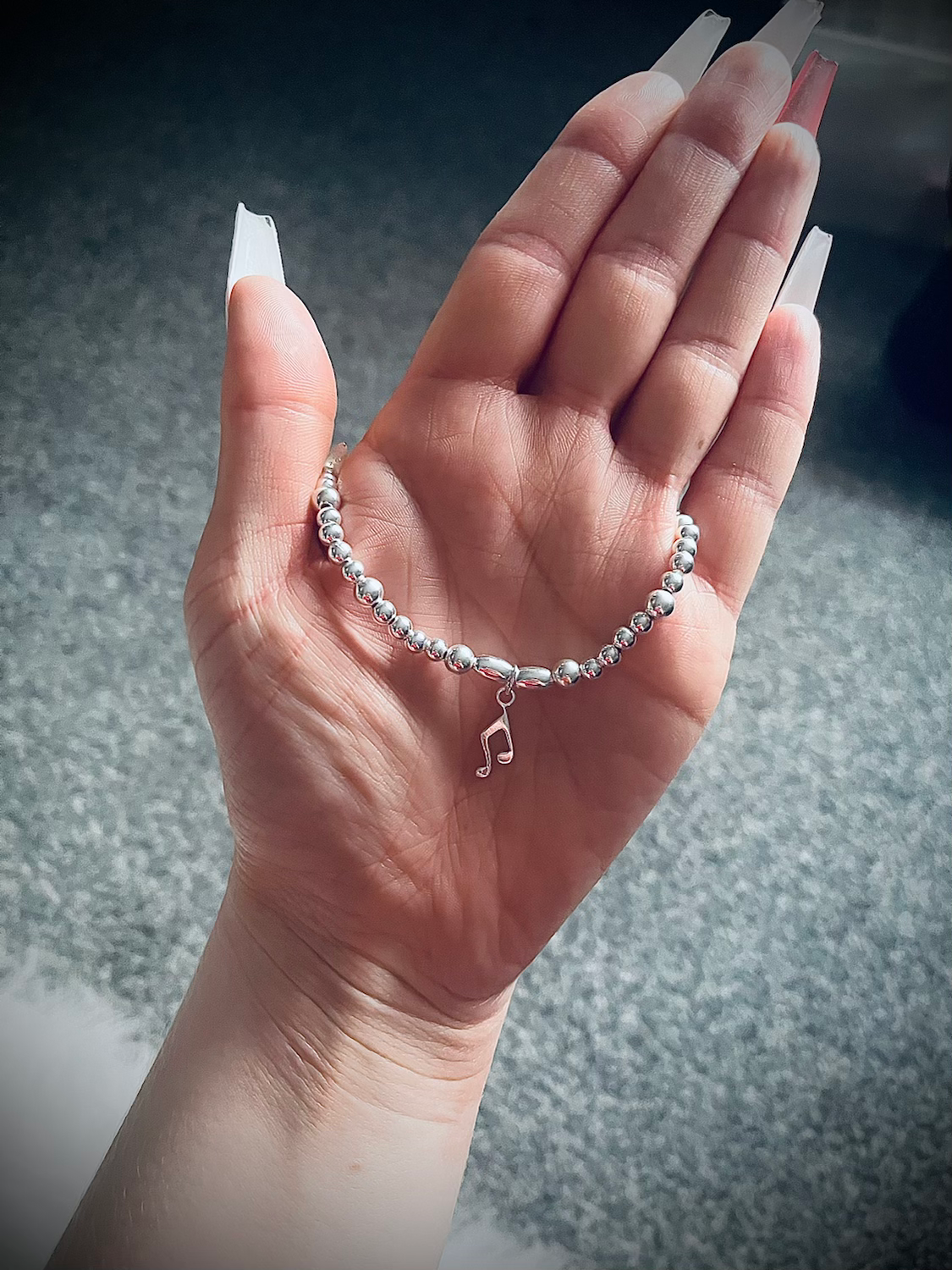 Sterling silver bracelet with music note charm.
