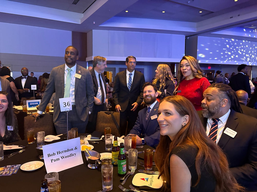 People in formal attire at a dinner event
