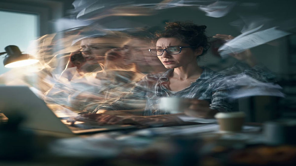 A Canadian woman sitting at her desk doing multiple calls at once in her Vancouver BC office