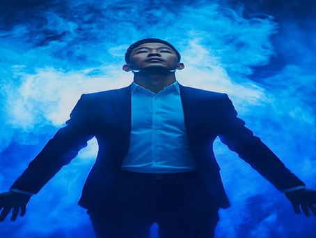 A Singaporean professional wearing a business suit floating in a surreal blue dreamscape looking upward arms outstretched