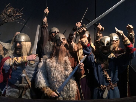 Viking warrior, male or female, in traditional attire, symbolizing the strength and mythological origins of Norse names."