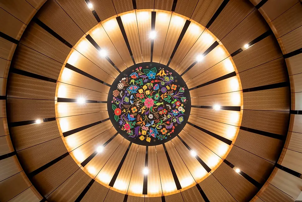 University of Alberta Commons: A New Campus Heart.
Circular wooden ceiling with bright lights and a colorful floral mandala mural in the center, viewed from below.