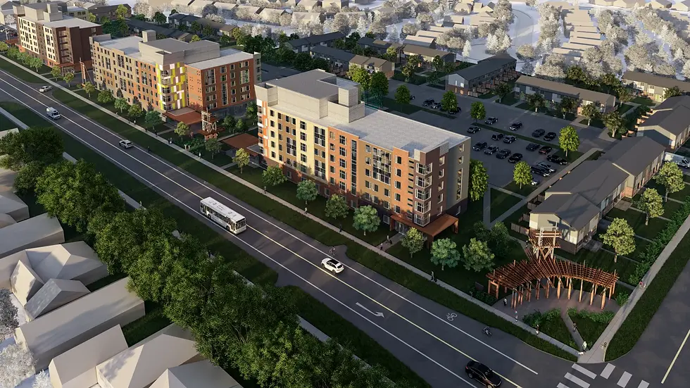 Aerial view of a residential area with modern buildings, green trees, and roads. Cars and a bus on the street, parking lot visible.