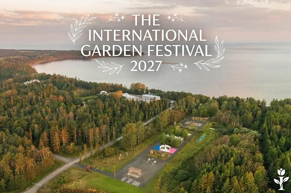 Aerial view of forest and lakeside festival site with text The International Garden Festival 2027 over a calm sunset shoreline.