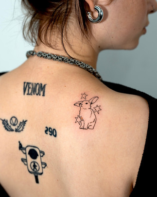 Rabbit doodle tattoo with character motifs on upper back, Seoul Ink Tattoo Gangnam 2026