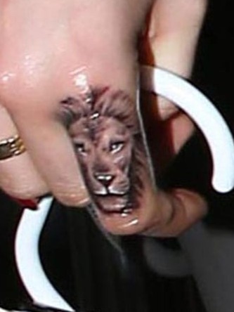 aa detailed lion tattoo on index finger