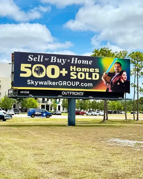 Skywalker Group billboard on US-1 showing more than 500 homes sold with Saud and Cinthia Rai.