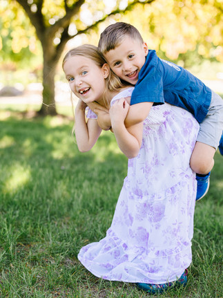 siblings playing during outdoor family session in plymouth minnesota
